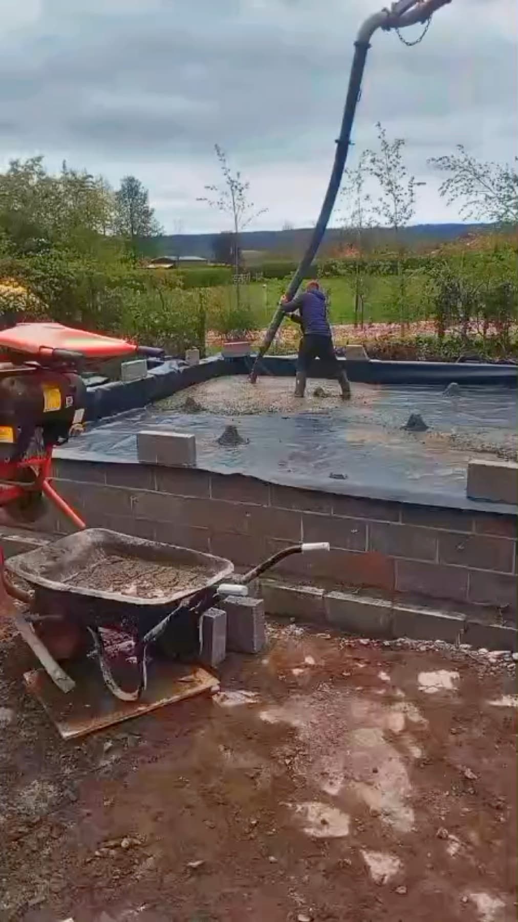 Concrete being pumped across a domestic construction project